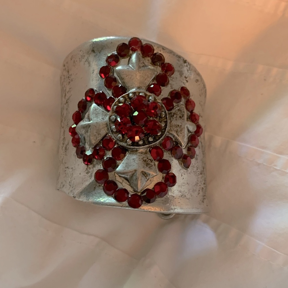Stunning ruby studded silver metal wrist cuff.